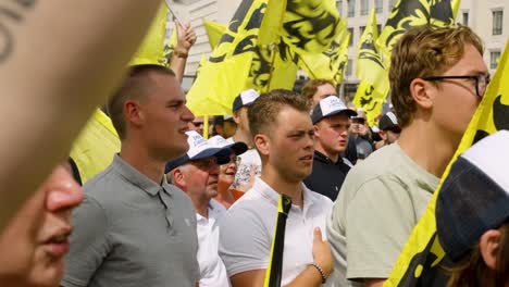 Supporters-of-Flemish-far-right-party-Vlaams-Belang-singing-anthem-during-protest-rally-in-Brussels,-Belgium