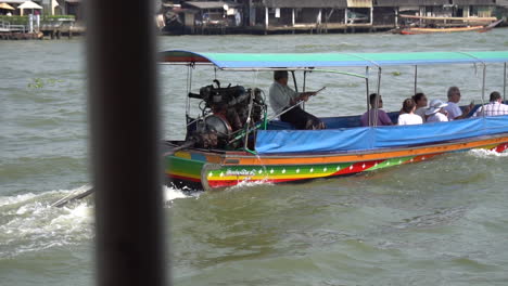 Slowmotion-of-Traditional-Long-Tail-Boat-and-Engine-on-Water-Taxi-in-Chao-Phraya-River,-Bangkok-Thailand