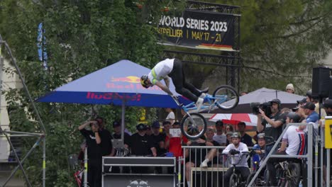 BMX-bike-racer-executing-double-tail-whip-trick-mid-air,slow-motion