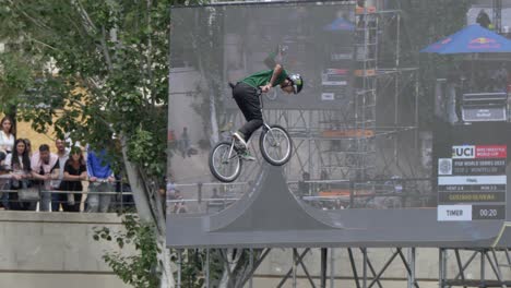 BMX-rider-lets-go-of-the-handlebars-and-spreads-his-arms-during-the-jump