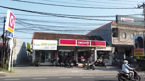 Circle-K-Ladeneingang-In-Sanur,-Bali,-Indonesien,-Straßenverkehr-Mit-Autos-Und-Motorrollern-Bei-Tageslicht,-Supermarkt,-Eröffnungsaufnahme,-Nachbarschaft