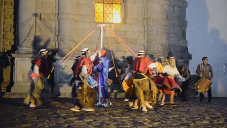 People-dancing-in-a-traditional-ceremony-in-Quito,-Ecuador,-at-dusk