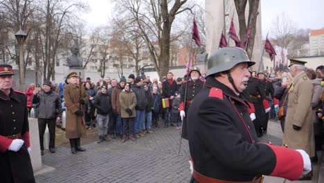 Retired,-old-veterans-marching-in-full-uniform-across-the-streets-of-Kaunas,-Lithuania-for-the-Restoration-of-the-State-celebration