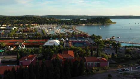 Drone-aerial-fast-left-rotating-flying-view-of-Portoroz-in-yellow-sunset-light,-Slovenia