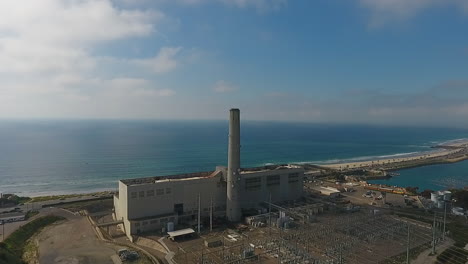 Cinematic-drone-shot-of-smokestack-at-the-NRG-Encina-Power-Plant-on-the-coast-of-Carlsbad,-CA