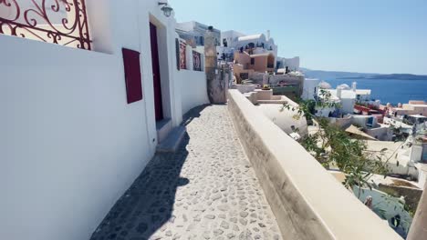 Oia-Santorini-Greece-Island-Travel-Tourist-Immersive-Walk,-Europe,-4K-|-Greek,-Aegean,-Sea,-Cliffside,-Ocean,-City,-Vacation,-Shopping,-White,-Marble,-Crowd,-Flowers,-Traveler,-People,-Path,-Vast-View