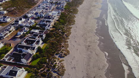 Drone-flight-over-long-sandy-Paternoster-beach-with-white-washed-coastal-houses