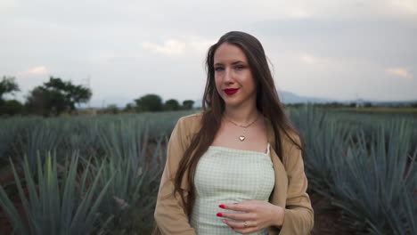 Pretty-young-woman-sensually-pushing-her-wind-blown-hair-back-in-Tequila-fields-in-Mexico---Medium-slow-motion-shot