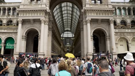 POV-Following-Walking-Group-Tour-Towards-Entrance-To-Galleria-Vittorio-Emanuele-II-in-Milan