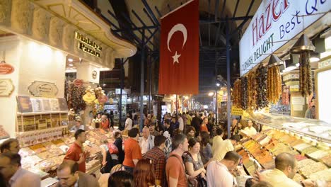 People-walking-around,-Turkish-Delight-stall-at-The-Grand-Bazaar-market,-Istanbul,-Turkey