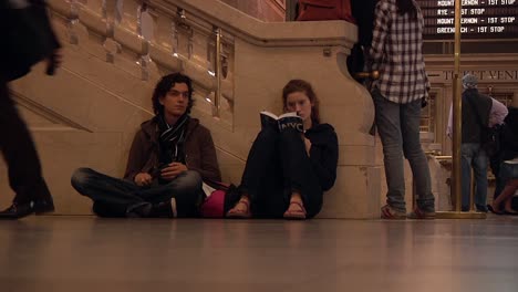 Young-tourist-couple-checks-out-New-York-city-map-while-sitting-inside-Grand-Central-Terminal