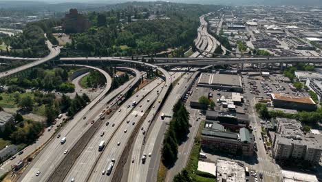 Drone-shot-of-cars-driving-on-Seattle's-freeway-system,-heading-out-of-the-city