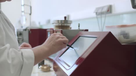 Lab-Worker-Using-Touch-Pen-On-Screen-Inside-Laboratory