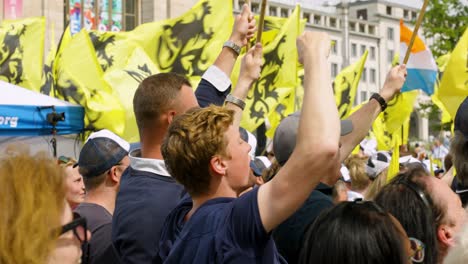 Supporters-of-Flemish-far-right-party-Vlaams-Belang-cheering-and-singing-during-protest-rally-in-Brussels,-Belgium