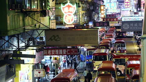 Public-Light-Buses-And-People-On-The-Terminal-At-The-Street-Side-In-Hong-Kong-Near-Commercial-Buildings---Timelapse