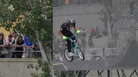 BMX-biker-performing-breathtaking-X-up,truckdriver-stunts-at-FISE-Montpellier