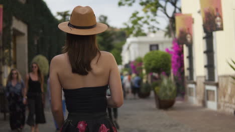 Cute-Hispanic-female-traveler-tourist-walking-through-the-streets-of-Tequila-town,-Jalisco,-Mexico