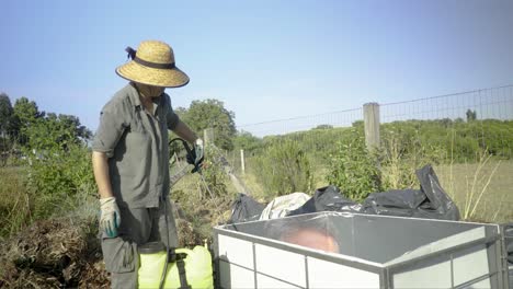 Peasant-prepares-a-compost-bin-in-a-small-farm