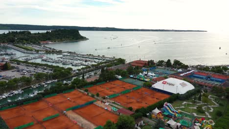 Drone-aerial-forward-flying-over-seaside-coastal-town-of-Portoroz---ATP-Challenger-Slovenia-Open-tennis-grounds