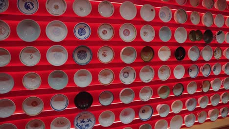 Wall-of-Ramen-Bowls-on-Display,-Pan-Shot-at-Yokohama-Ramen-Museum