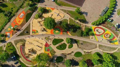 Overhead-View-Of-Kids-Playing-At-Children's-Playground-In-Uzvaras-Parks,-Jelgava,-Latvia