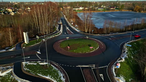 Aerial-big-roundabout-town-infrastructure-intersection-in-winter-with-light-traffic-in-rural-town