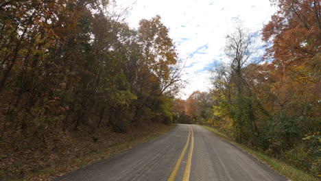 POV-From-Car-Driving-In-The-Road-Along-The-Forest-At-Devil's-Den-State-Park-During-Autumn-In-Washington,-Arkansas,-United-States