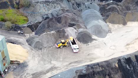 Tipper-loading-lorry-with-gravel-in-Quarry