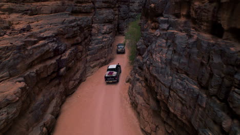 Offroad-Vehicles-Driving-Through-Rock-Formations-On-Desert-In-Tassili-N'Ajjer-National-Park,-Illizi,-Algeria