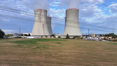 Flying-under-electric-line-wires-toward-nuclear-power-plant-cooling-towers