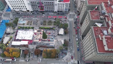Holiday-Season-in-Full-Swing-Elevated-side-pan-drone-footage-of-Union-Square,-showcasing-the-bustling-holiday-scene-with-a-majestic-Christmas-tree-and-ice-rink