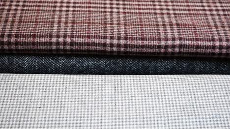 Close-up-of-plaid-fabric-texture-samples-in-different-color-at-tailor-studio