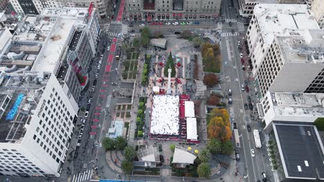 Overhead-drone-capture-of-Union-Square,-featuring-the-ice-rink-and-Christmas-tree-surrounded-by-the-bustle-of-city-life