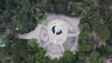 upper-angle-Drone-video-were-people-can-be-seen-touring-the-top-of-the-well-known-and-historic-Anna-Nagar-Tower-Park,-an-urban-park-situated-in-the-Anna-Nagar-suburb-of-Chennai