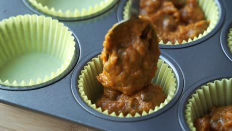Using-spoon-and-Adding-batter-to-pan-for-vegan-pumpkin-muffins-using-real-roasted-pumpkin-in-bowl-healthy-dairy-free-recipe-vegan