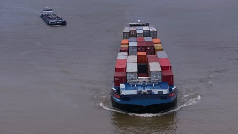 Container-ship,-FPS-IJSSEL-closely-followed-behind-by-smaller-vessel
