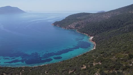 Aerial-view-of-paradise-beach-of-Firnaz-Koyu-with-blue-waters-of-Mediterranean-Sea-and-mountains,-Turkey