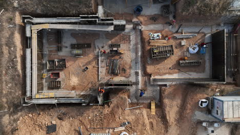 Aerial-view-looking-down-over-construction-crew-working-on-property-foundation-site