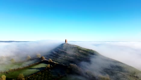 Drone-footage-of-mist-flowing-over-Glastonbury-tor
