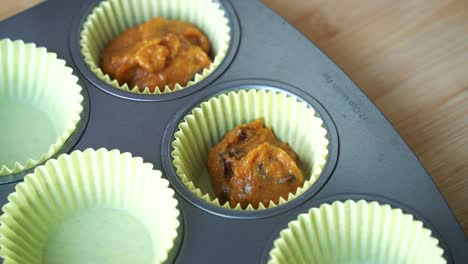 Close-up-of-batter-being-added-to-silicone-muffin-for-vegan-pumpkin-muffins-using-real-roasted-pumpkin-in-bowl-healthy-dairy-free-recipe-vegan