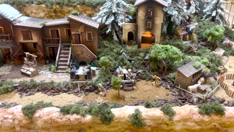 Close-up-view-of-a-miniature-Christmas-village,-capturing-the-charm-and-festivity-of-the-holiday-season