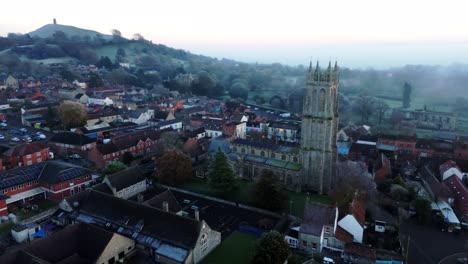 Aerial-shot-of-Church-with-Glastonbury-Tor-in-background