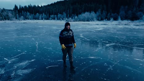 Norwegian-Man-Walking-In-The-Frozen-Omundvatnet-Lake-In-Winter-In-Indre-Fosen,-Trondelag,-Norway