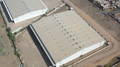 aerial-drone-shot-drone-camera-top-side-showing-a-large-warehouse-for-storing-logic-sticks