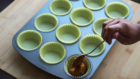 Adding-batter-to-pan-for-vegan-pumpkin-muffins-using-real-roasted-pumpkin-in-bowl-healthy-dairy-free-recipe-vegan