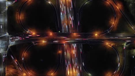 Timelapse-Of-Traffic-at-Cloverleaf-Interchange,-Butterfly-shaped-Road-Intersection-At-Night