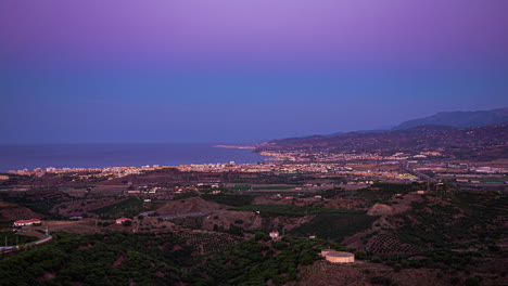 In-Spanien-Fängt-Eine-Zeitrafferperspektive-Das-Beleuchtete-Schauspiel-Der-Lichter-Der-Stadt-Ein-Und-Ergänzt-Den-Panoramablick-Auf-Den-Strand-Von-Malaga