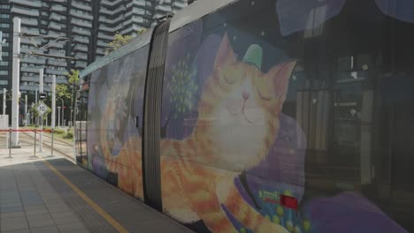 Cat-mural-on-city-tram-at-Danhai-light-rail-metro,-LRT-station,-Tamsui,-New-Taipei