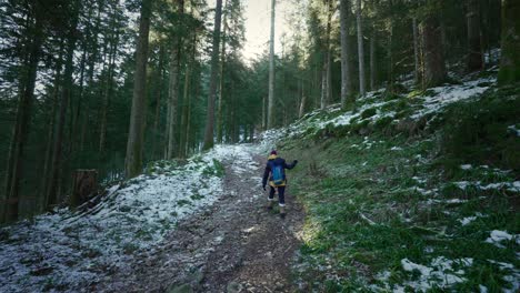 Winter-Hike:-Caucasian-Woman-Leads-the-Way-Through-Snowy-Forest