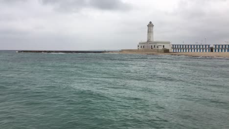Landscape-with-lighthouse-in-San-Cataldo-near-Lecce,-Italy-in-overcast-weather-in-off-season